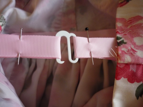 make a loop in the other end of the ribbon and pin